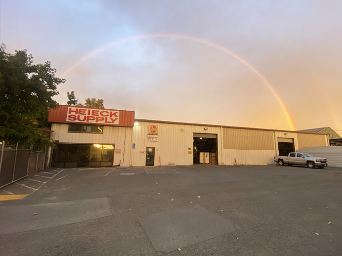 Heieck Supply building exterior with rainbow in background